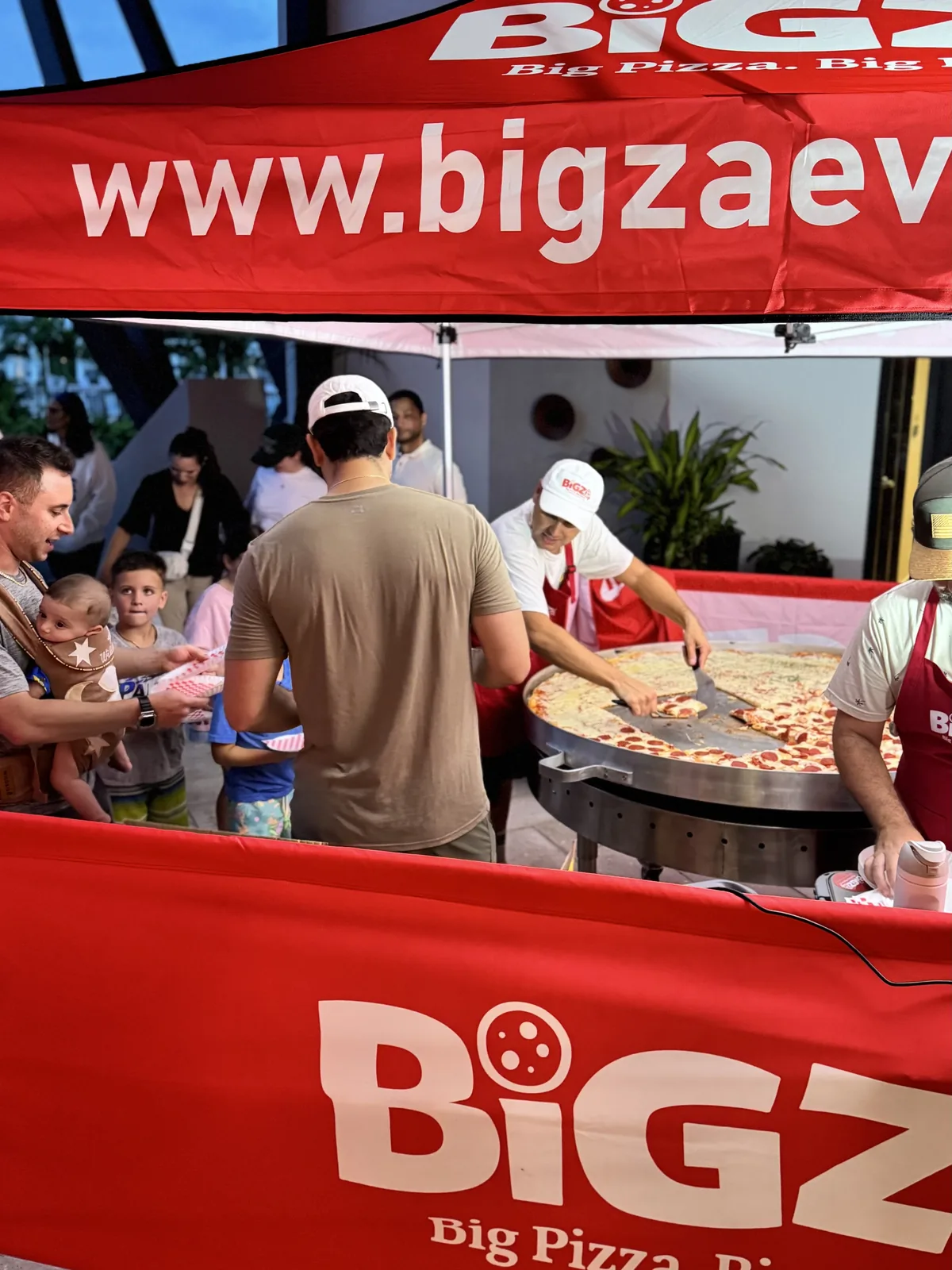 How big is Bigza? Size comparisons showing the 5-foot pizza next to a banana, an adult, a car and more — 2 of 4